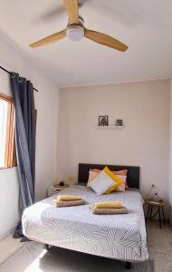 a bedroom with a bed with a ceiling fan at La Casita de Puerto in Puerto del Rosario