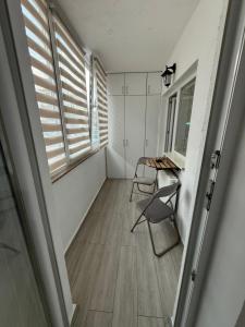 a room with a table and chairs and a window at House in Cisnădie