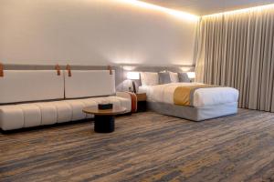 a hotel room with a bed and a couch at Royal Palace Hotel - Almoroj in Riyadh