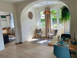 a living room with a table and chairs at Apartments Aura & Nova in Aue-Bad Schlema
