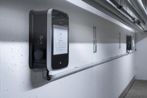 a cell phone dispenser on a wall in a room at GLEUEL INN HOTEL - Serviced Apartments in Hürth