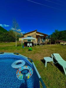 a backyard with a table and a bench and a house at HOMELAND in Mestia