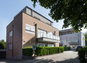 a building with a sign on the side of it at GLEUEL INN HOTEL - Serviced Apartments in Hürth