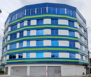 a blue and white building with windows at Hospedarte Cali Sur in Cali