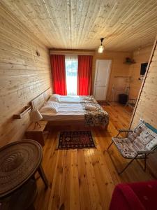 a bedroom with a bed and a window in a room at HOMELAND in Mestia