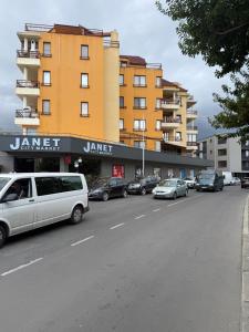 a street with cars parked in front of a building at LADA Apartment in Nesebar +17 photos