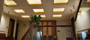 a room with a ceiling with skylights at Hotel Shlok Inn in Somnath