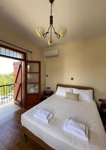 a bedroom with a bed with two towels on it at Villa Saint George - Stone Costa in Kathikas
