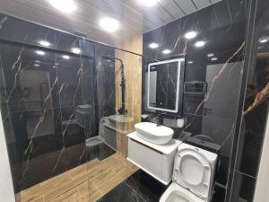 a bathroom with a toilet and a sink and a mirror at New apartment in centre Yerevan in Yerevan +13 photos