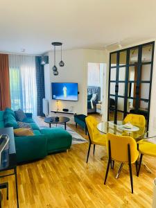 a living room with a blue couch and a table at Citysmart Apartment in Tuzla