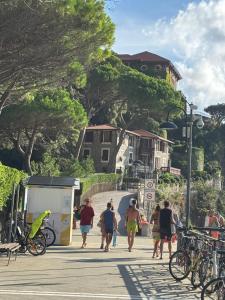 a group of people walking down a sidewalk at Mai senza Mare in Levanto