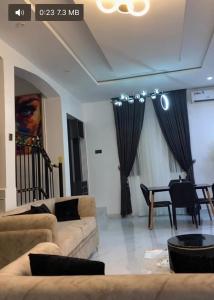a living room with a couch and a table at Strobbs Residence in Uyo