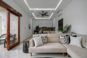 a living room with a couch and a ceiling fan at Stunning 2 bed Beachside Villa Brand New in Sanur