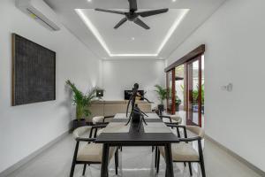 a dining room with a table and a ceiling fan at Stunning 2 bed Beachside Villa Brand New in Sanur