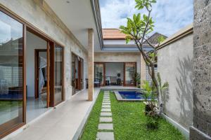 an external view of a house with a garden at Stunning 2 bed Beachside Villa Brand New in Sanur