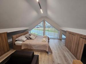 a bedroom with a bed and a large window at Apartament KONGRESOWA VIEW in Kielce