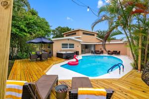 a swimming pool with a red swan in a backyard at Luxury Clearwater Villa with Pool, Hot Tub, Games and More in Clearwater
