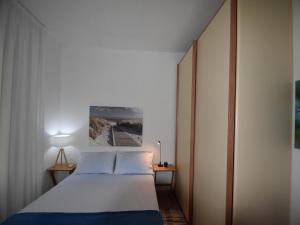 a bedroom with a bed and a painting on the wall at Chalet by Lake Maggiore with Garden Views in Verbania +25 photos