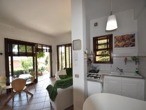 a kitchen and a living room with a table at Chalet by Lake Maggiore with Garden Views in Verbania