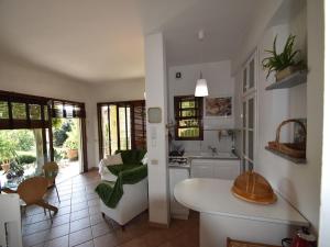 a kitchen and living room with a table and chairs at Chalet by Lake Maggiore with Garden Views in Verbania