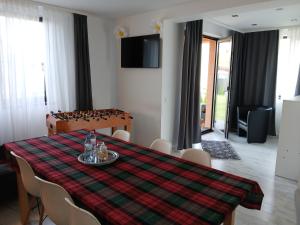 a dining room table with a plaid table cloth on it at Lux - Confort in Sînpetru