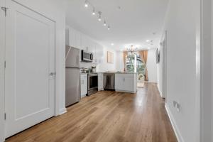 a kitchen with white cabinets and a wooden floor at Downtown Atlanta Home Away from Home - 2 in Atlanta