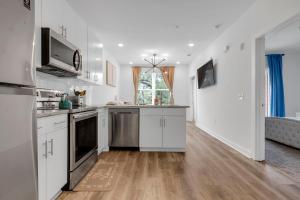 a kitchen with white cabinets and stainless steel appliances at Downtown Atlanta Home Away from Home - 2 in Atlanta