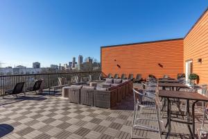 a patio with tables and chairs on a building at Downtown Atlanta Home Away from Home - 2 in Atlanta
