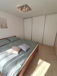 a bedroom with a bed with two pillows on it at Apartmán Dukla in Pardubice