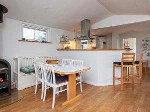 a kitchen with a table and chairs and a stove at 6 person holiday home in Gørlev in Gørlev