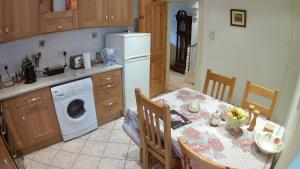 a kitchen with a table and a white refrigerator at Jim's Place in Dublin