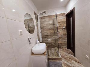 a bathroom with a sink and a mirror at Apartmány Alexander in Vrbov +16 photos