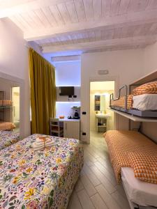 a hotel room with two beds and a bathroom at BelSorrisoVarese - Elegance City Residence Private Parking -Reservation Required- in Varese +204 photos