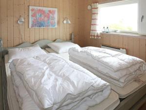 two beds sitting on a table in a bedroom at 4 star holiday home in Hadsund in Hadsund