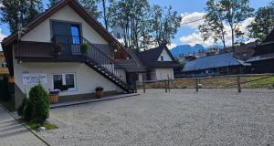 a house with a staircase on the side of it at Apartament Jaskier in Zakopane