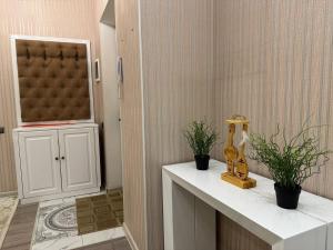 a bathroom with a counter with two plants on it at Promenade EXPO in Astana