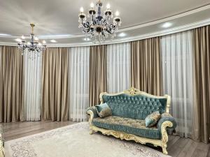a living room with a blue couch and a chandelier at Promenade EXPO in Astana +72 photos