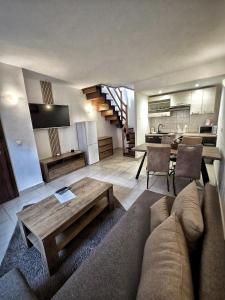 a living room with a couch and a table and a kitchen at Apartmány Alexander in Vrbov