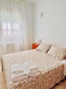 a bedroom with a bed with towels on it at Casa Ramón in Vélez-Rubio +9 photos