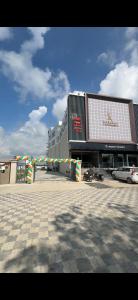 a city street with a large building and a parking lot at Kamala Inn Grand in Padrauna +3 photos