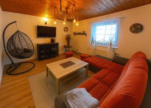 a living room with a couch and a table at Chalupa v Oblacích in Jindřichov