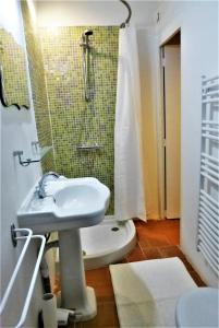 a bathroom with a sink and a shower at La Cachette village in Roussillon