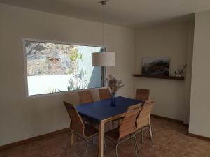 a dining room with a blue table and chairs at Ático encima del mar in Santa Cruz de la Palma +21 photos
