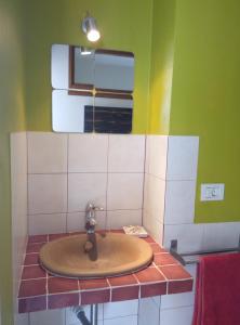 a sink in a bathroom with green and white at Ático encima del mar in Santa Cruz de la Palma