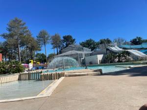 a water park with a water slide and a fountain at L'écureuil in Piriac-sur-Mer