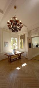 Habitación grande con lámpara de araña y suelo de madera. en Résidence de Tourisme Vacances Bleues Villa Regina, en Arcachon 22 fotos más