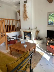 a living room with a table and a fireplace at Villa Lola in Bargemon