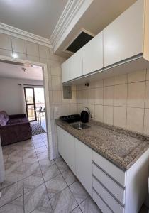 a kitchen with a sink and a counter top at Apê Brisa do Mar in Pontal do Paraná