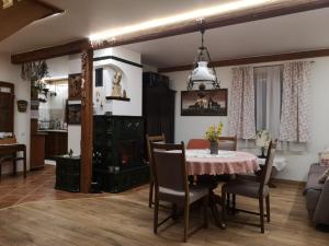 a dining room with a table and a living room at DOMEK LUBENIA in Lubenia
