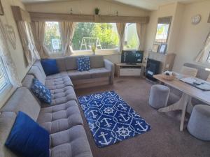 a living room with a couch and a table at Spacious and Modern - 188 Unity Beach Holiday Resort Unity Brean - Central Location 6 birth Pet Stays Free in Brean